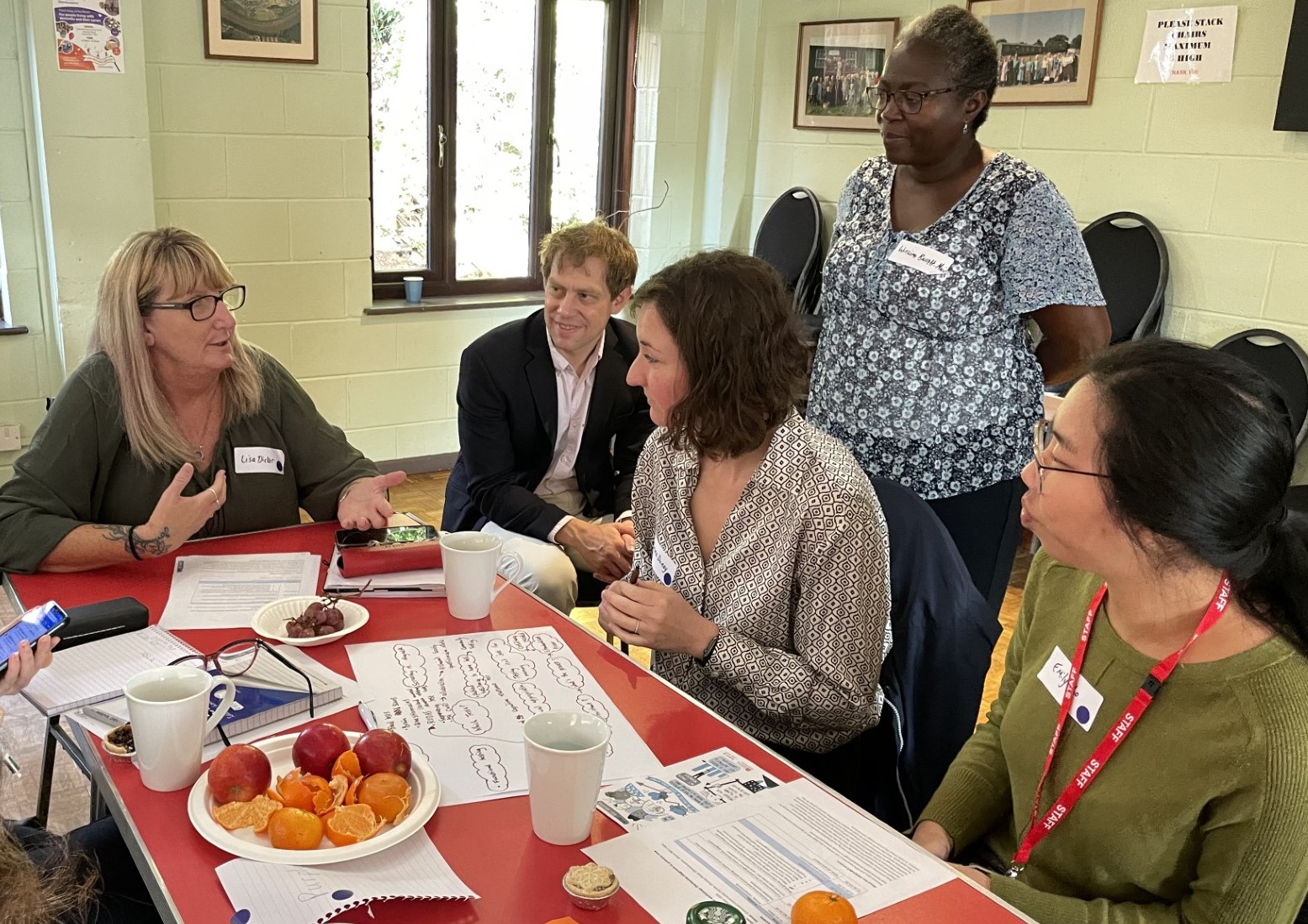 group of people in discussion fruit on table